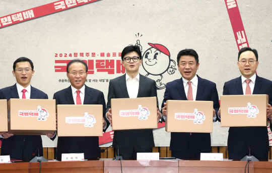 '국민의힘 한동훈 비상대책위원장과 윤재옥 원내대표 등이 15일 국회에서 열린 제22대 총선 공약개발본부 출범식에서 '정책 주문, 배송 프로젝트'를 상징하는 택배상자를 들고 포즈를 취하고 있다. 왼쪽부터 공동총괄본부장을 맡은 정우성 포항공대 교수, 윤 원내대표, 한 위원장, 공동총괄본부장을 맡은 유의동 정책위의장과 홍석철 서울대 교수.연합뉴스